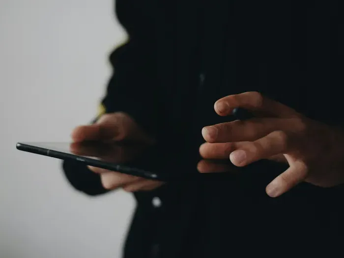 Close-up of hands operating a smartphone, symbolizing digital search and business connectivity on townservicefinder.com